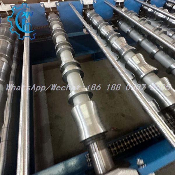 Close-up of CNC-turned 45# steel forming rollers with hard chrome plating on a profile sheet making machine — Trapezoidal Roof Panel Forming Machine roller station detail