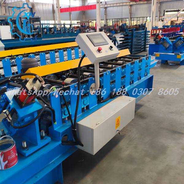 Side view of metal stud roll forming machine with control console