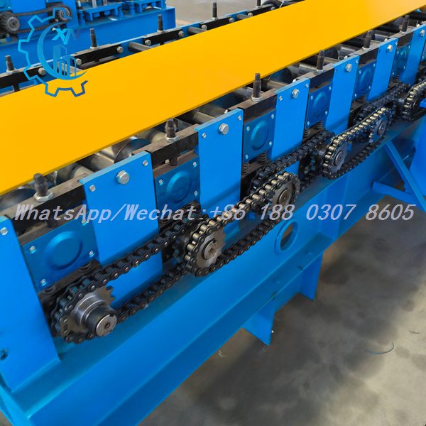Yellow strip being formed by metal stud roll forming machine with chain drive