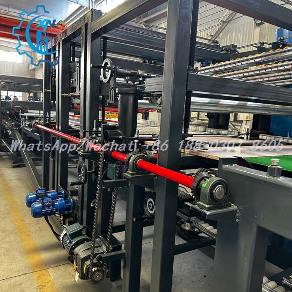 Red drive shaft and blue motors on rock wool sandwich panel line