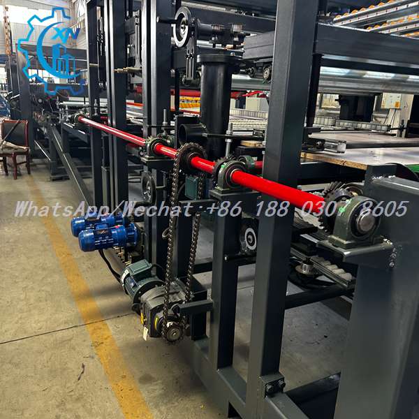 Blue motors and chain drive on sandwich panel making machine