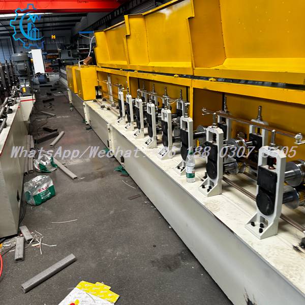 Full forming line with yellow covers on PU foam shutter door machine