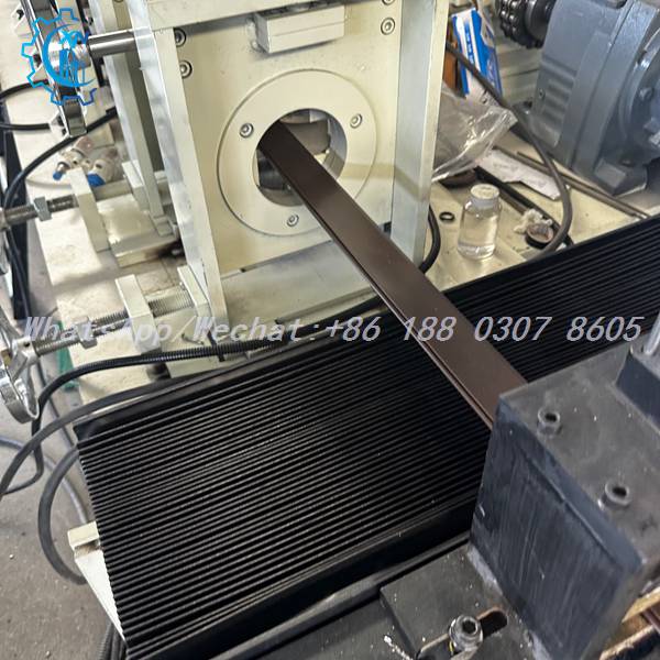 Forming rollers in enclosed stand on PU foam shutter door machine
