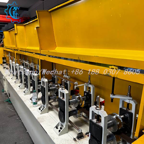 Yellow guards and stands on rolling shutter door roll forming machine